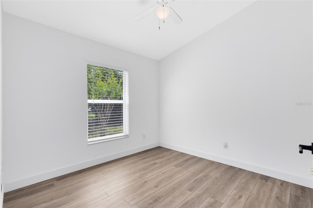 5809 Donnelly Circle Orlando, FL 32821 - Photo 16 of 22 wooden floor in an empty room with a window