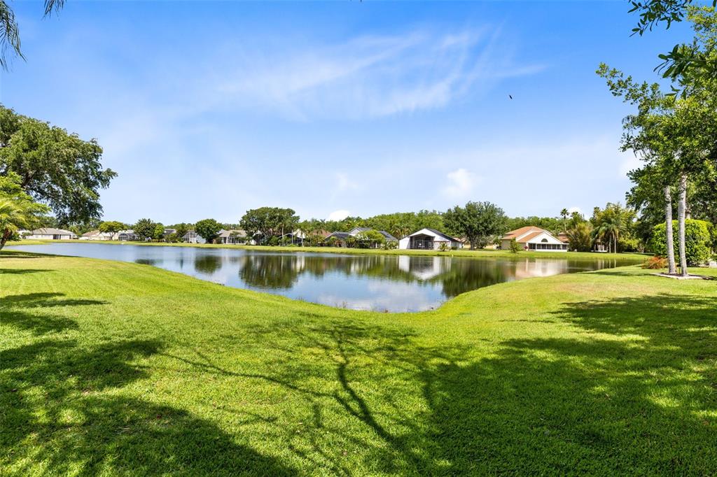 5809 Donnelly Circle Orlando, FL 32821 - Photo 21 of 22 a view of a lake with houses in the back