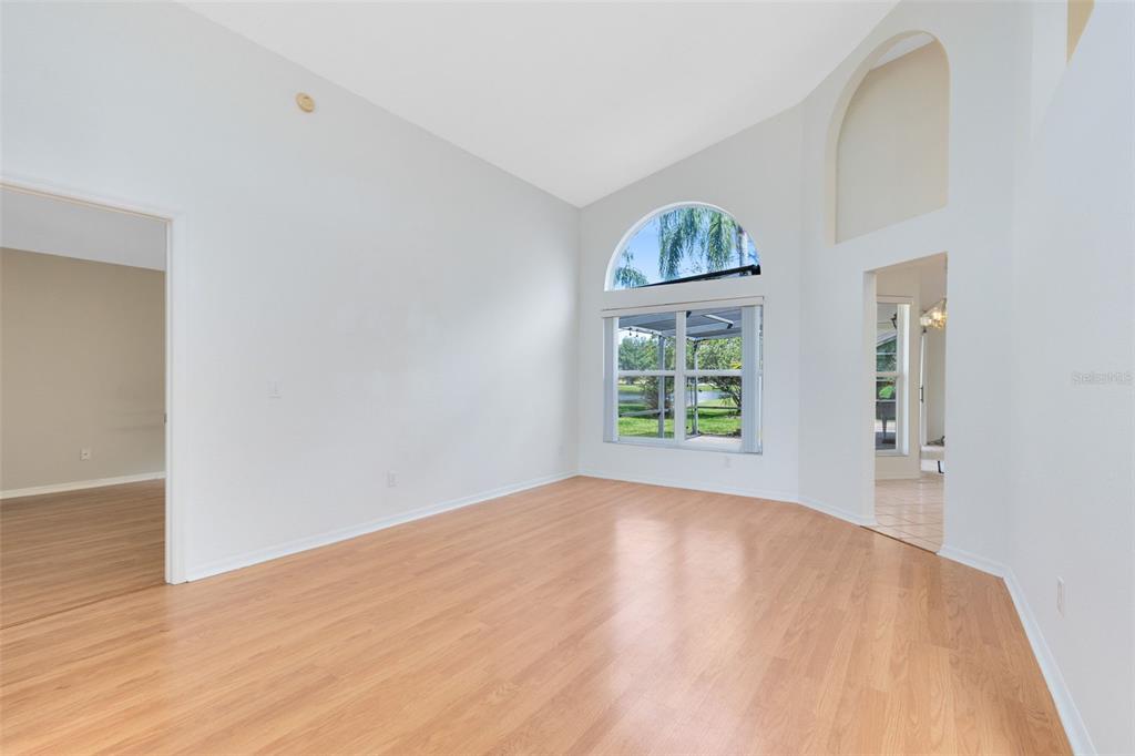5809 Donnelly Circle Orlando, FL 32821 - Photo 5 of 22 wooden floor in an empty room with a window