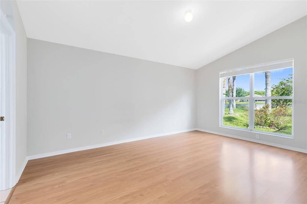 5809 Donnelly Circle Orlando, FL 32821 - Photo 6 of 22 a view of an empty room with wooden floor and a window