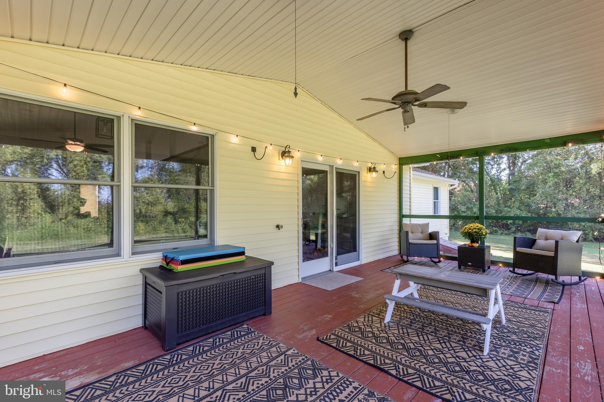 15902 Trenton Road Upperco, MD 21155 - Photo 11 of 57 a living room with furniture a rug and a floor to ceiling window