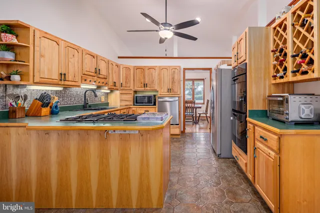 a kitchen with stainless steel appliances granite countertop a sink and cabinets