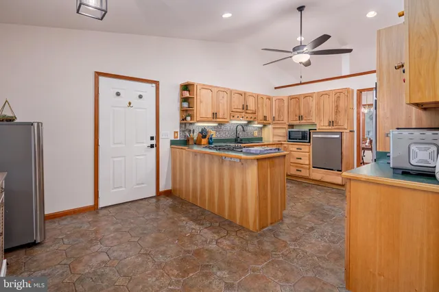 a dining room with furniture a chandelier and wooden floor