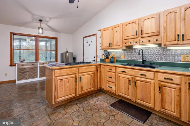 a view of a livingroom with wooden floor and a large window