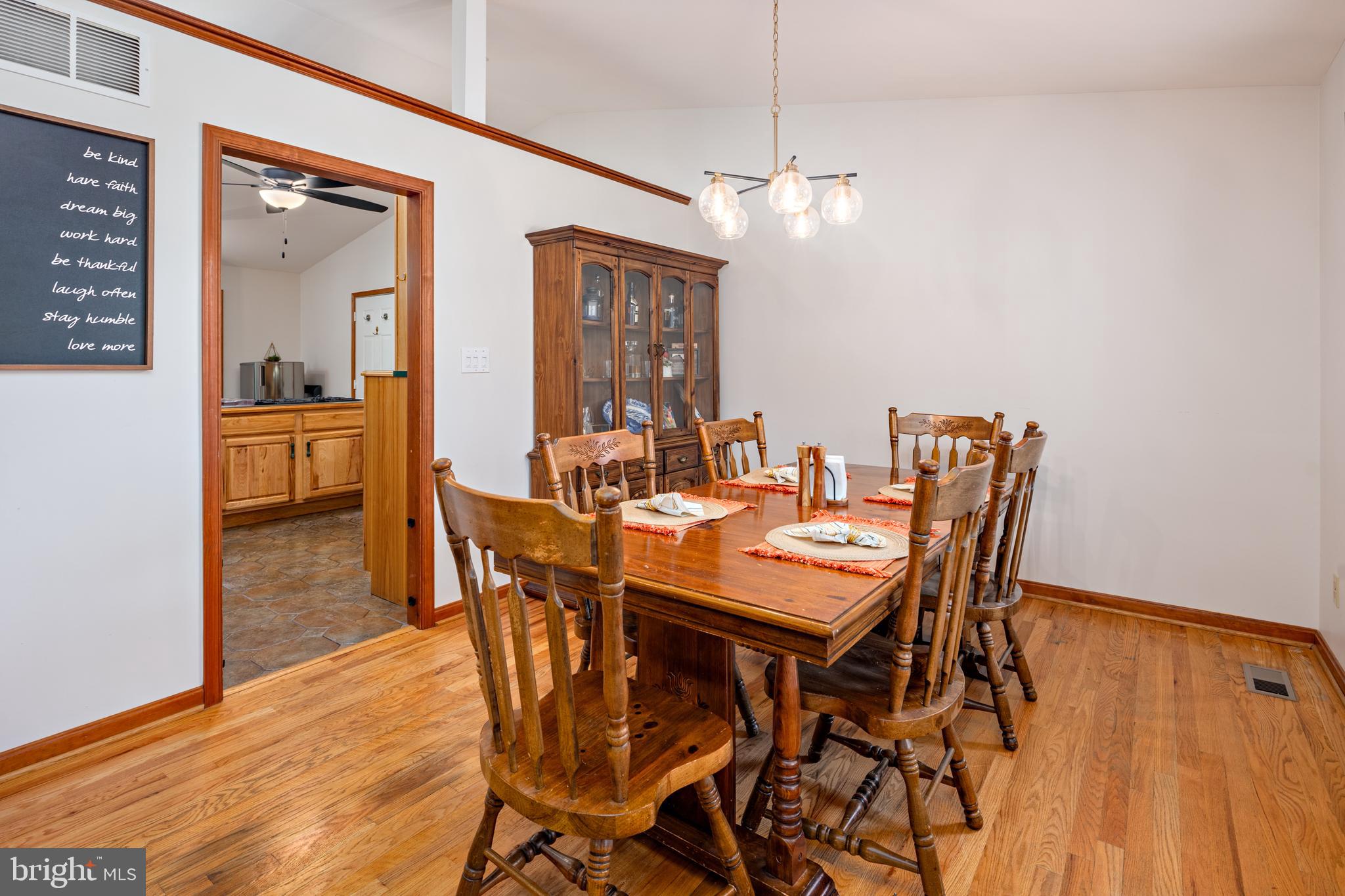 15902 Trenton Road Upperco, MD 21155 - Photo 24 of 57 a dining room with furniture a chandelier and wooden floor