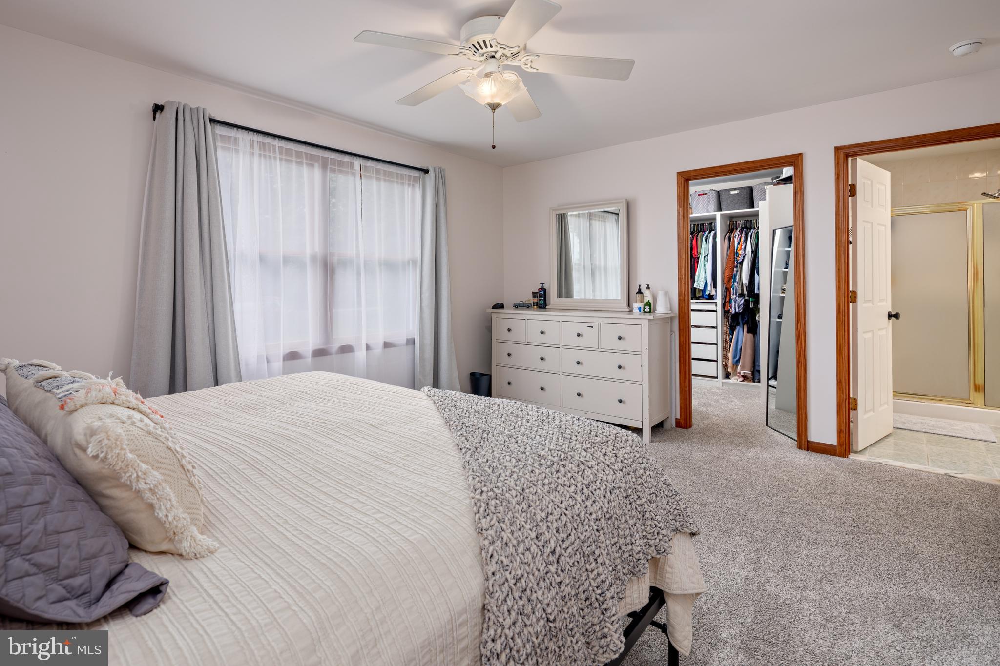15902 Trenton Road Upperco, MD 21155 - Photo 30 of 57 a spacious bedroom with a bed and a chandelier