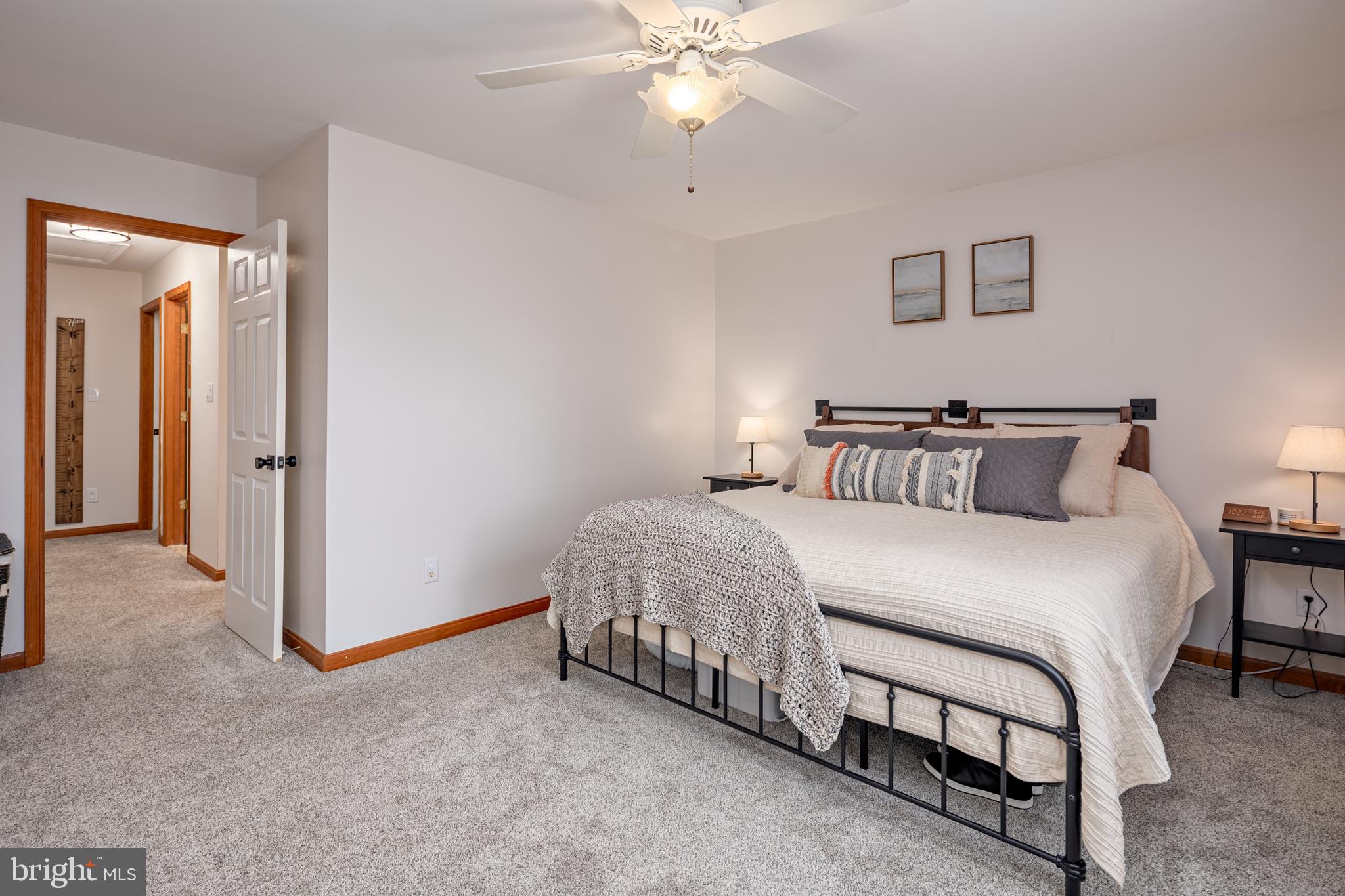 15902 Trenton Road Upperco, MD 21155 - Photo 32 of 57 a spacious bedroom with a bed and a chandelier
