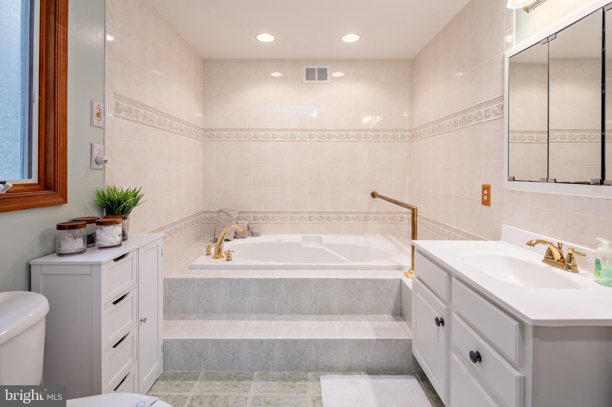 15902 Trenton Road Upperco, MD 21155 - Photo 35 of 57 a bathroom with a bathtub sink vanity mirror and toilet