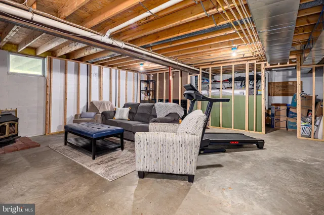 a room with gym equipment and wooden floor