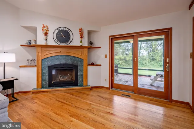 a view of a porch with furniture and wooden floor