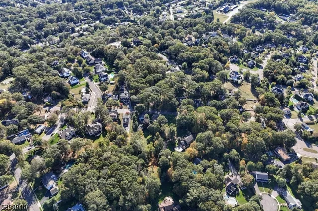an aerial view of a houses with a yard