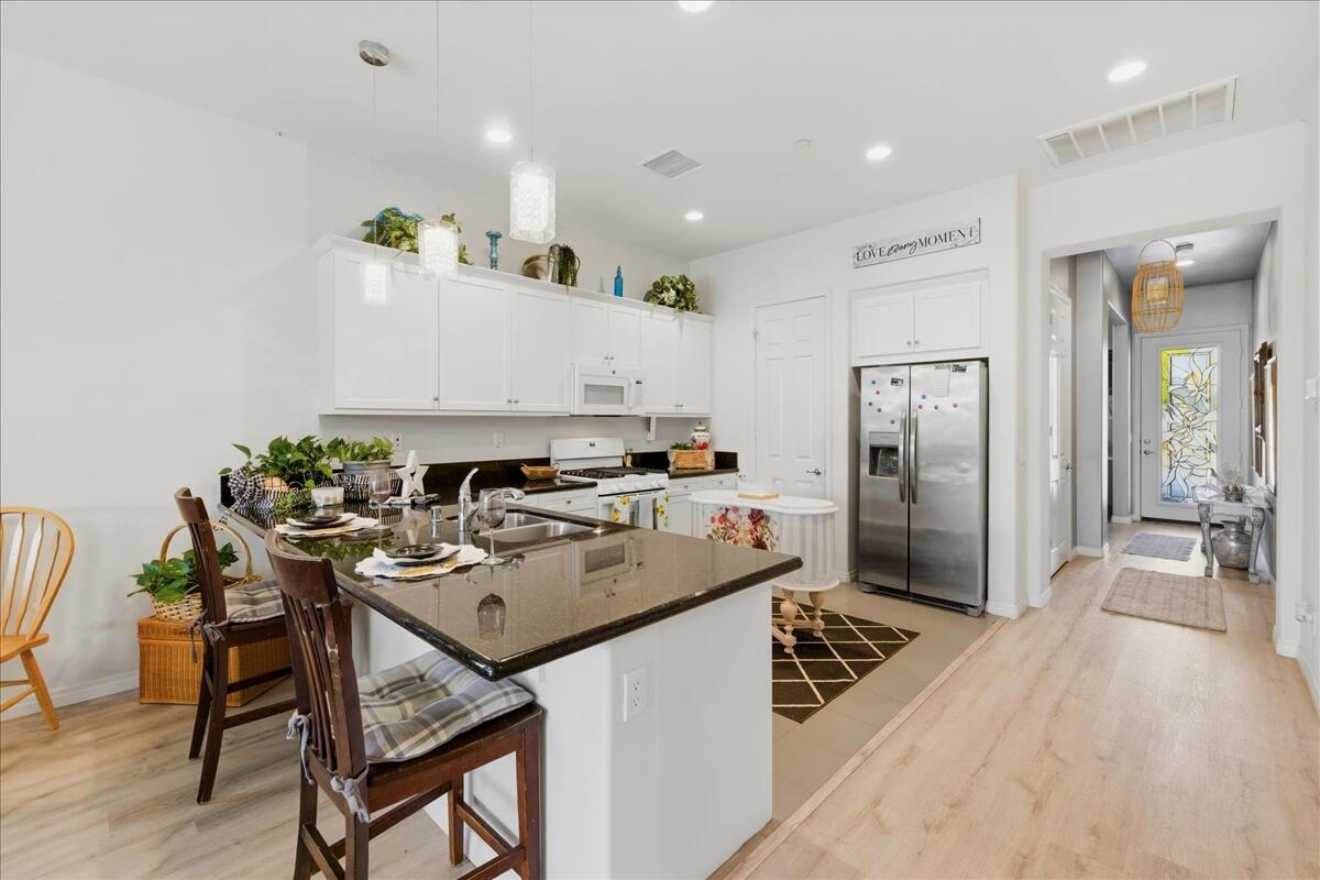 44027 Triolo Way Indio, CA 92203 - Photo 5 of 30 Kitchen w/ Island Seating