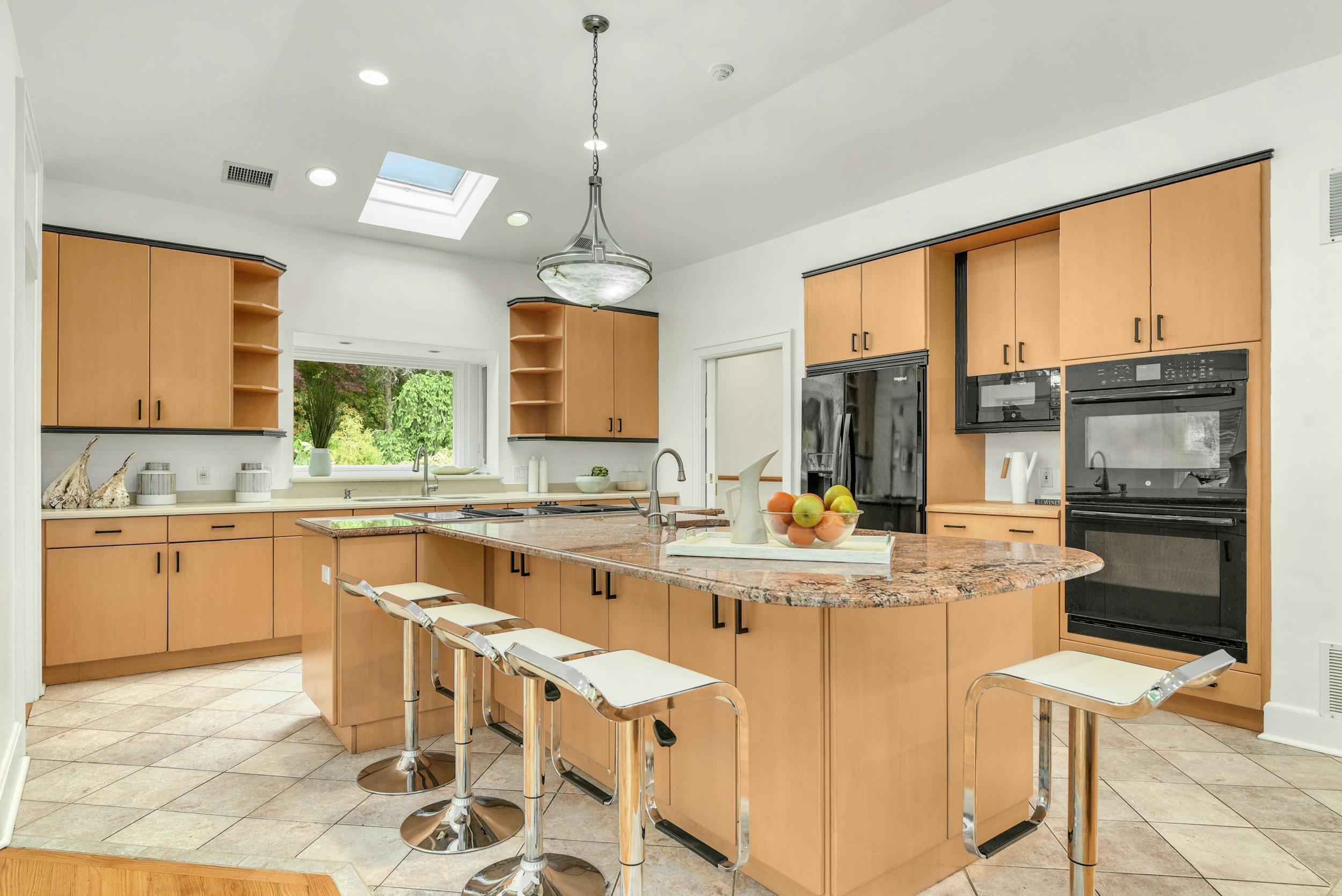 1315 Smith Ridge Road New Canaan, CT 06840 - Photo 16 of 54 a kitchen with stainless steel appliances granite countertop a stove top oven a sink dishwasher a dining table and chairs with wooden floor