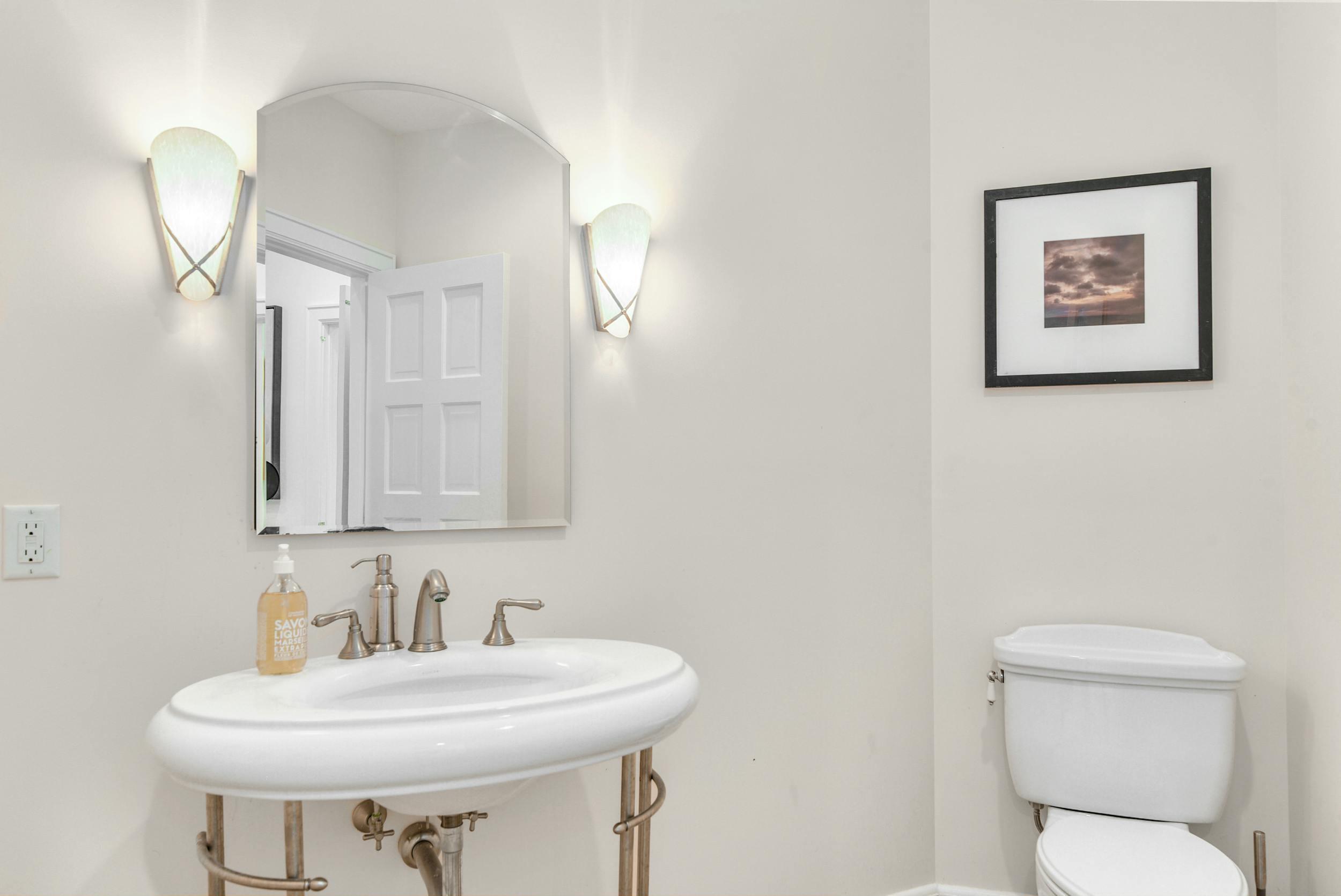 1315 Smith Ridge Road New Canaan, CT 06840 - Photo 17 of 54 a bathroom with a toilet sink and mirror