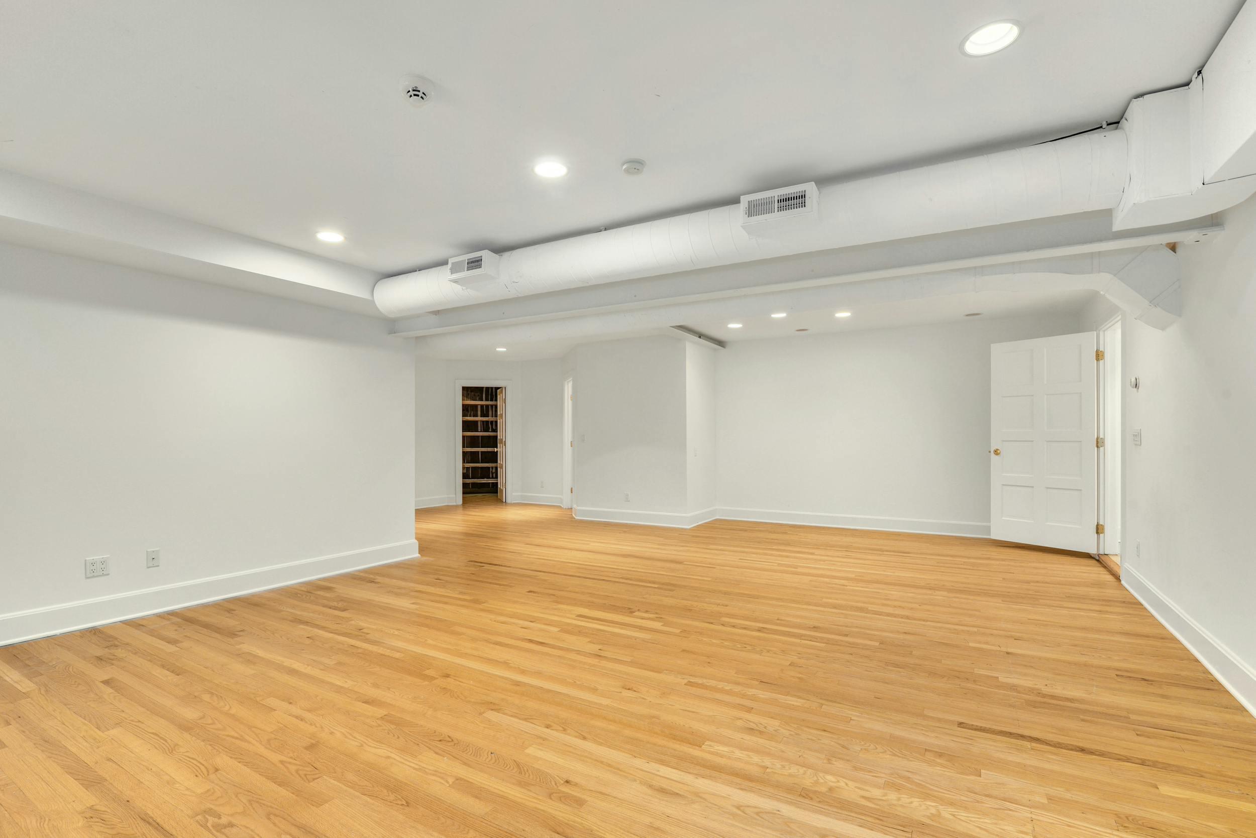 1315 Smith Ridge Road New Canaan, CT 06840 - Photo 35 of 54 a view of an empty room with wooden floor and a window