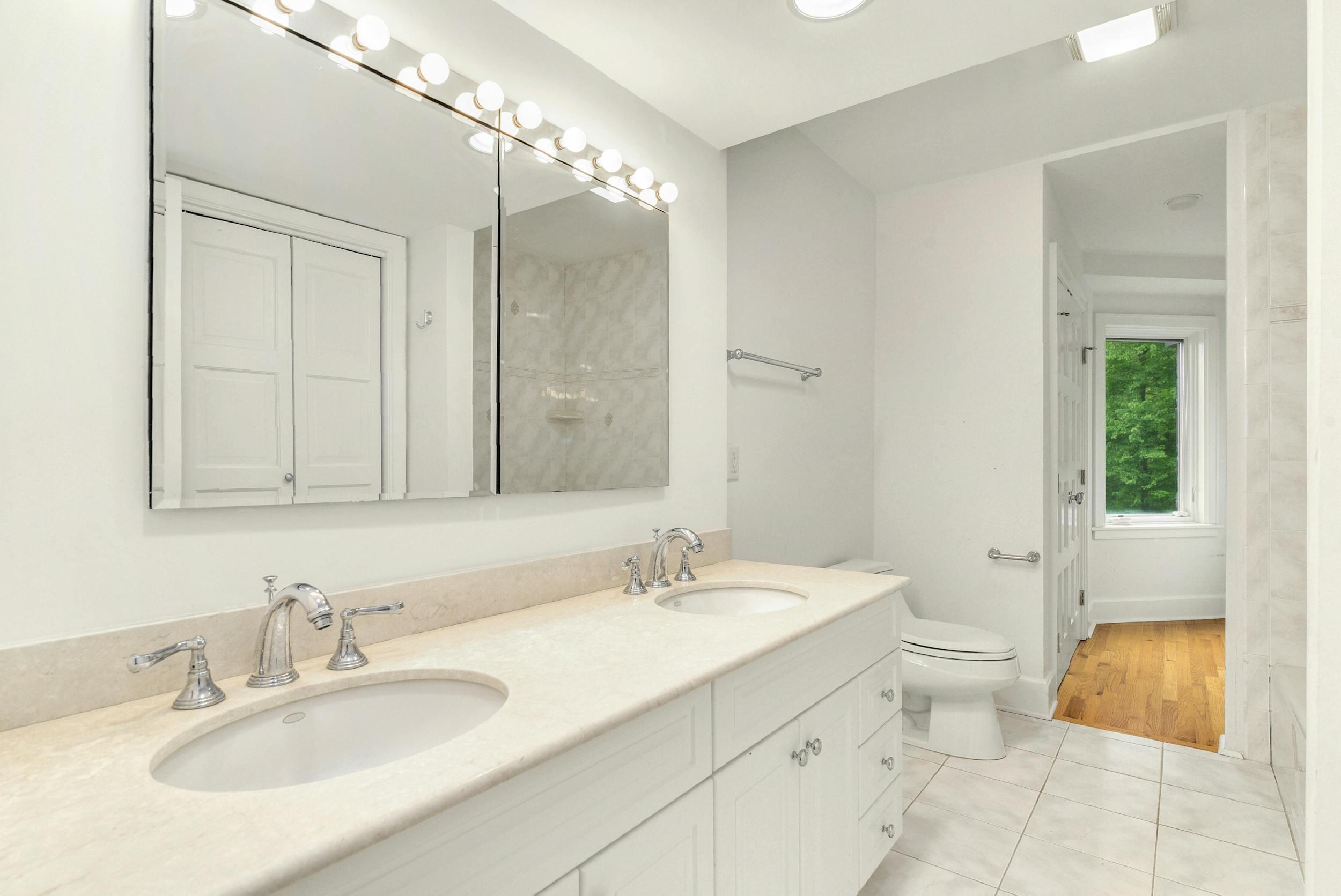 1315 Smith Ridge Road New Canaan, CT 06840 - Photo 40 of 54 a bathroom with a granite countertop sink toilet and shower