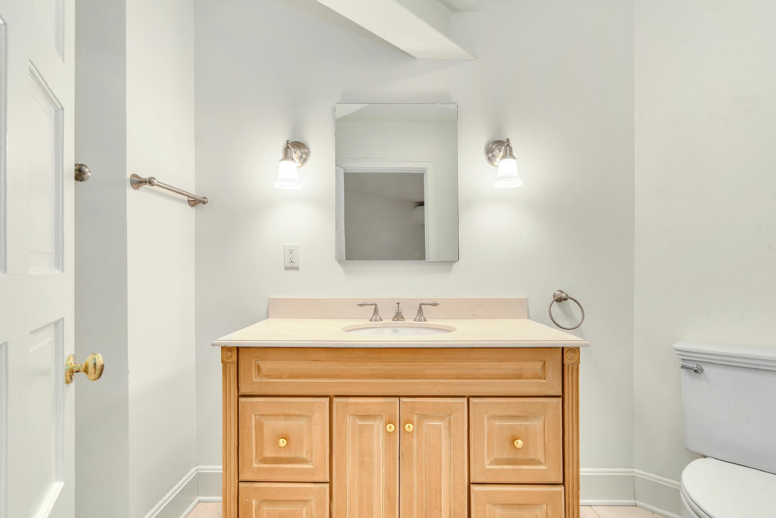 1315 Smith Ridge Road New Canaan, CT 06840 - Photo 41 of 54 a bathroom with a sink vanity and a mirror