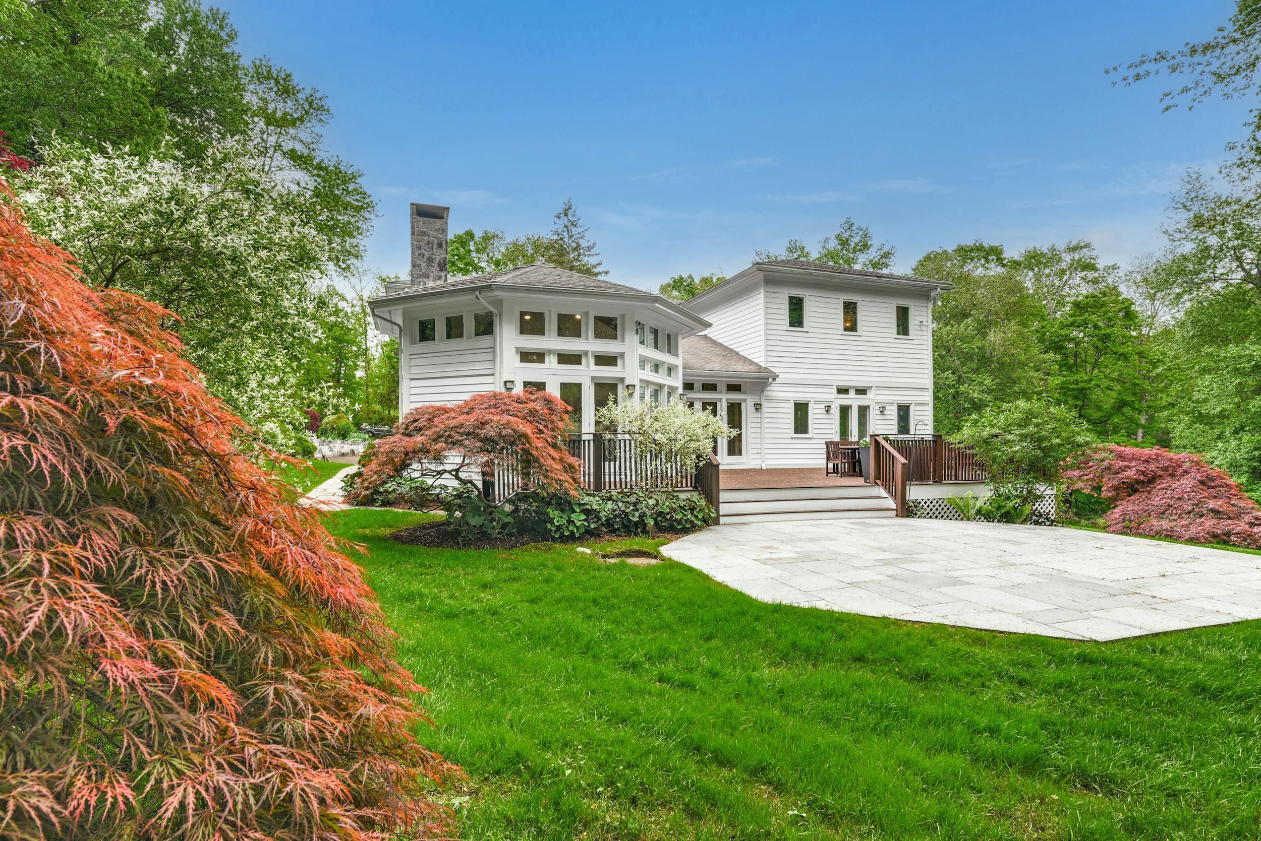 1315 Smith Ridge Road New Canaan, CT 06840 - Photo 46 of 54 a front view of a house with a garden