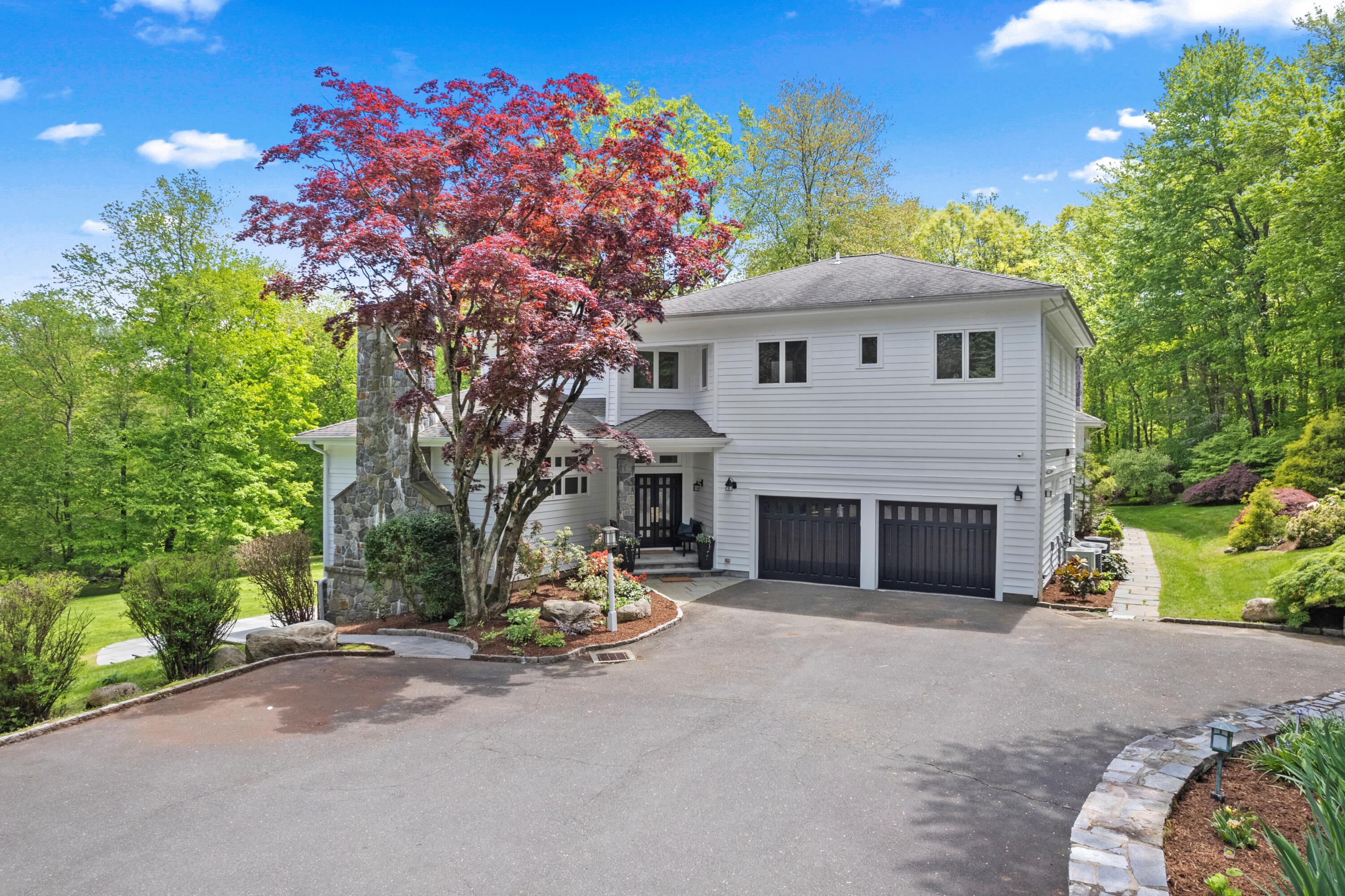 1315 Smith Ridge Road New Canaan, CT 06840 - Photo 47 of 54 a view of a house with a yard and potted plants