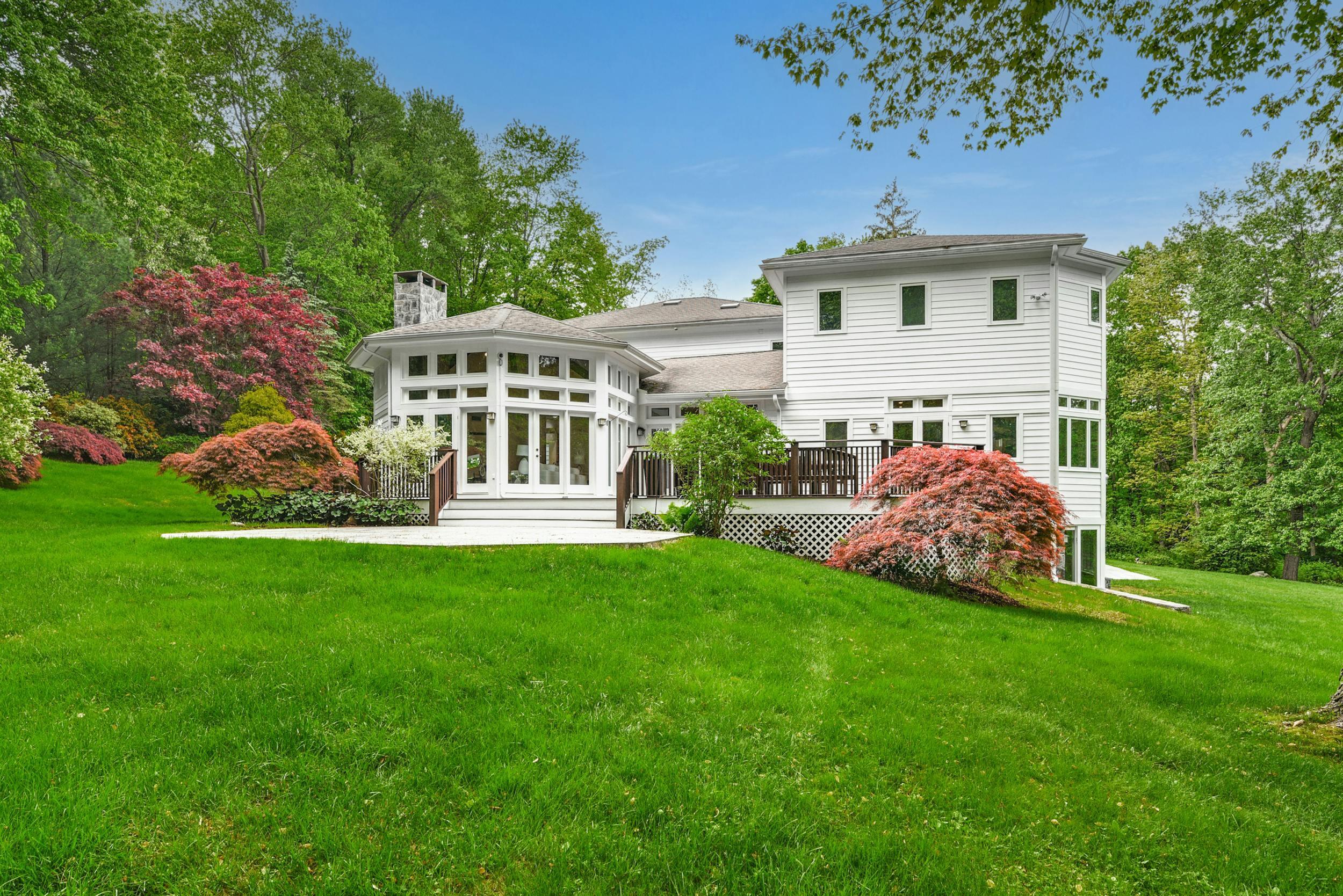1315 Smith Ridge Road New Canaan, CT 06840 - Photo 49 of 54 a view of a house with a backyard porch and sitting area