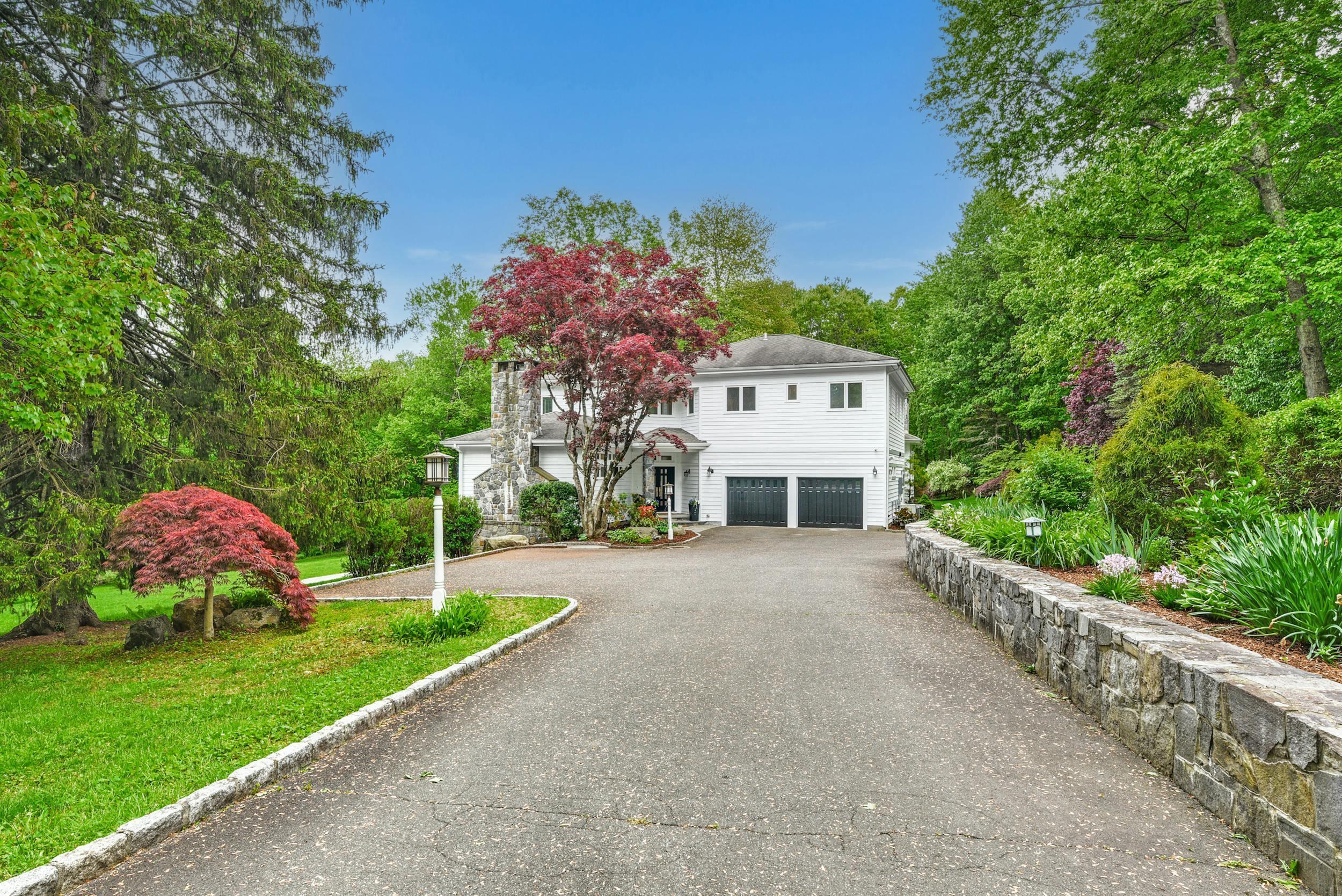 1315 Smith Ridge Road New Canaan, CT 06840 - Photo 50 of 54 a front view of a house with garden