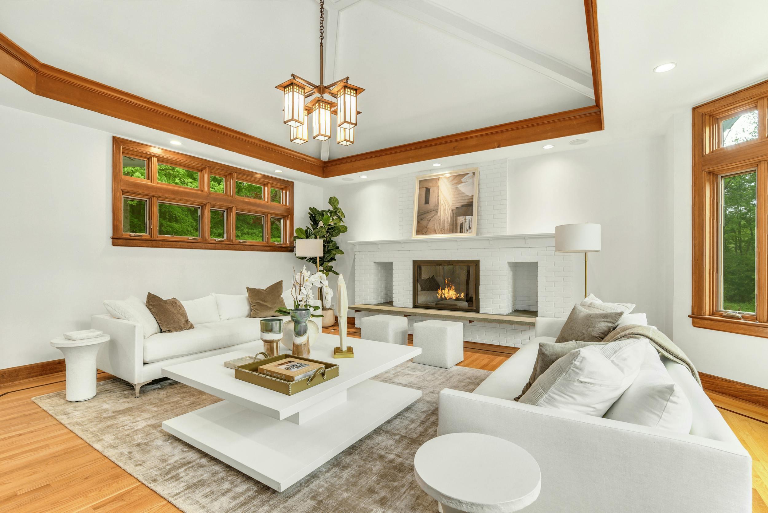 1315 Smith Ridge Road New Canaan, CT 06840 - Photo 5 of 54 a living room with furniture a chandelier and a fireplace