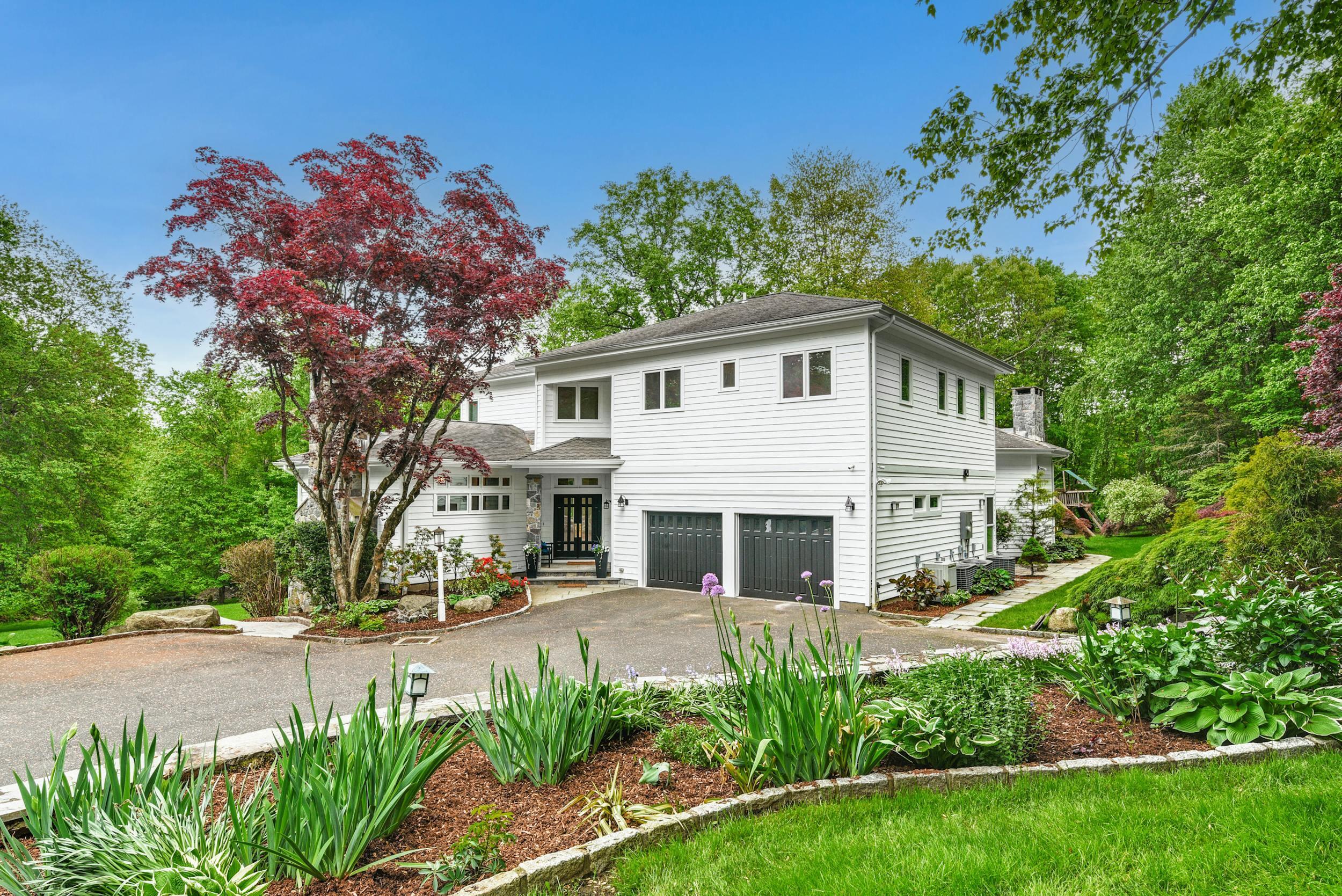 1315 Smith Ridge Road New Canaan, CT 06840 - Photo 53 of 54 a front view of a house with a yard