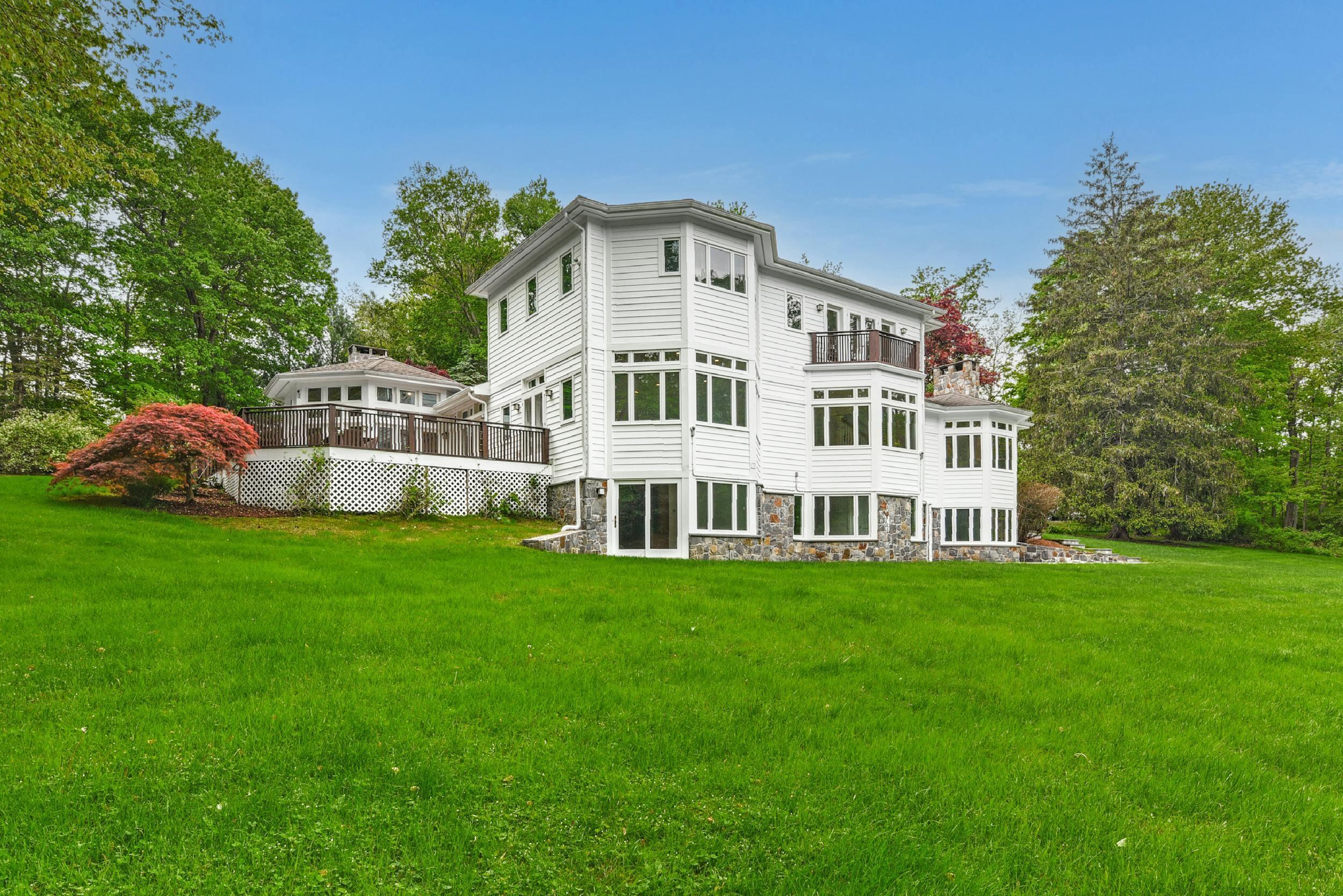 1315 Smith Ridge Road New Canaan, CT 06840 - Photo 54 of 54 a front view of a house with a garden