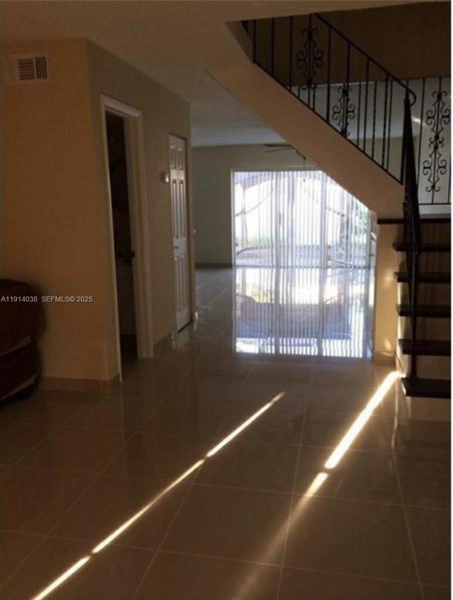 3928 Southwest 67th Way, Unit 97 Davie, FL 33314 - Photo 3 of 9 a view of an empty room with a window