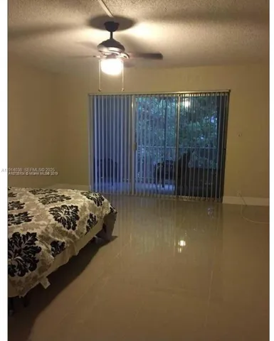 a bedroom with bed and window