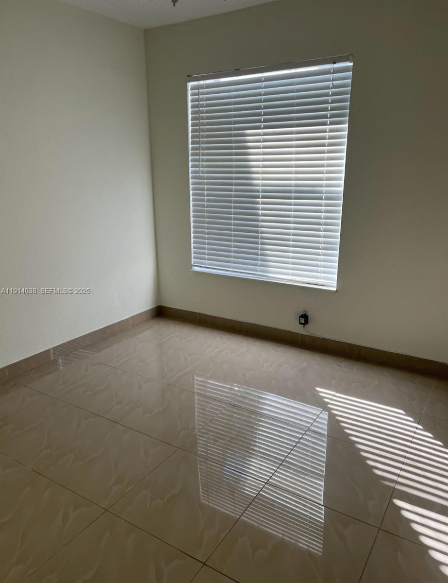 3928 Southwest 67th Way, Unit 97 Davie, FL 33314 - Photo 8 of 9 a view of an empty room with a window