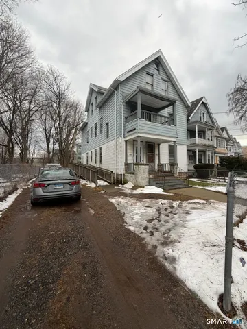 a front view of a building with a yard