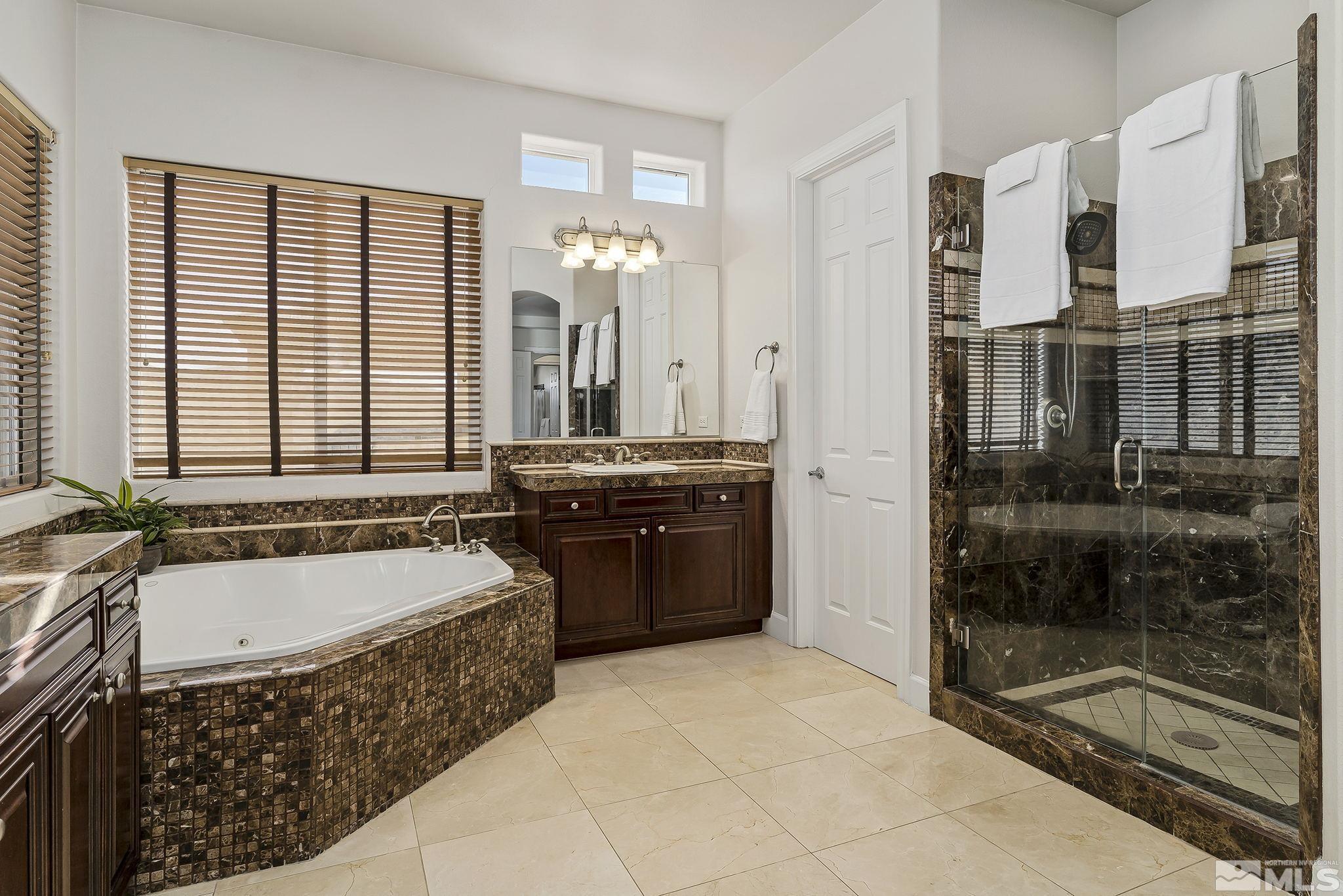 3528 Desert Fox Drive Sparks, NV 89436 - Photo 17 of 35 a bathroom with a tub a sink and a shower