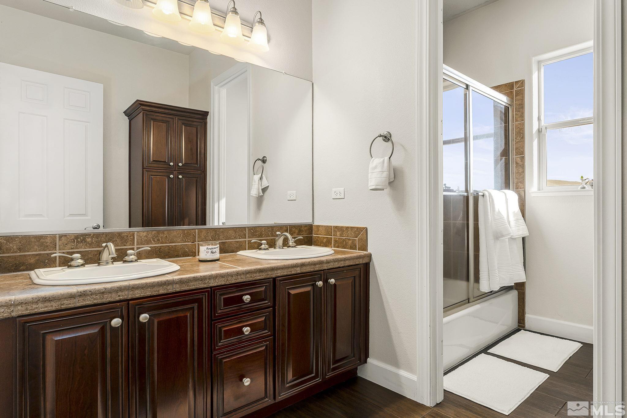 3528 Desert Fox Drive Sparks, NV 89436 - Photo 21 of 35 a bathroom with a double vanity sink and mirror