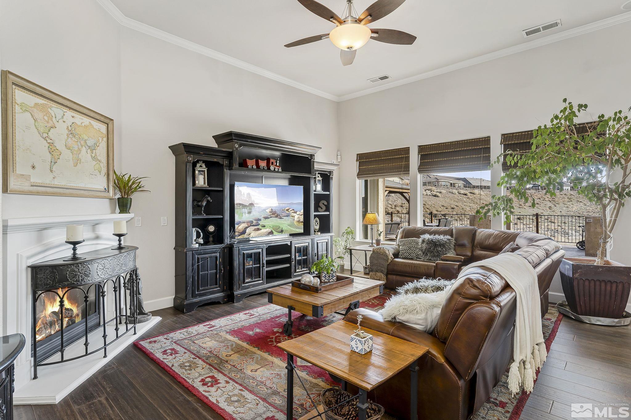 3528 Desert Fox Drive Sparks, NV 89436 - Photo 3 of 35 a living room with furniture a flat screen tv and a fireplace