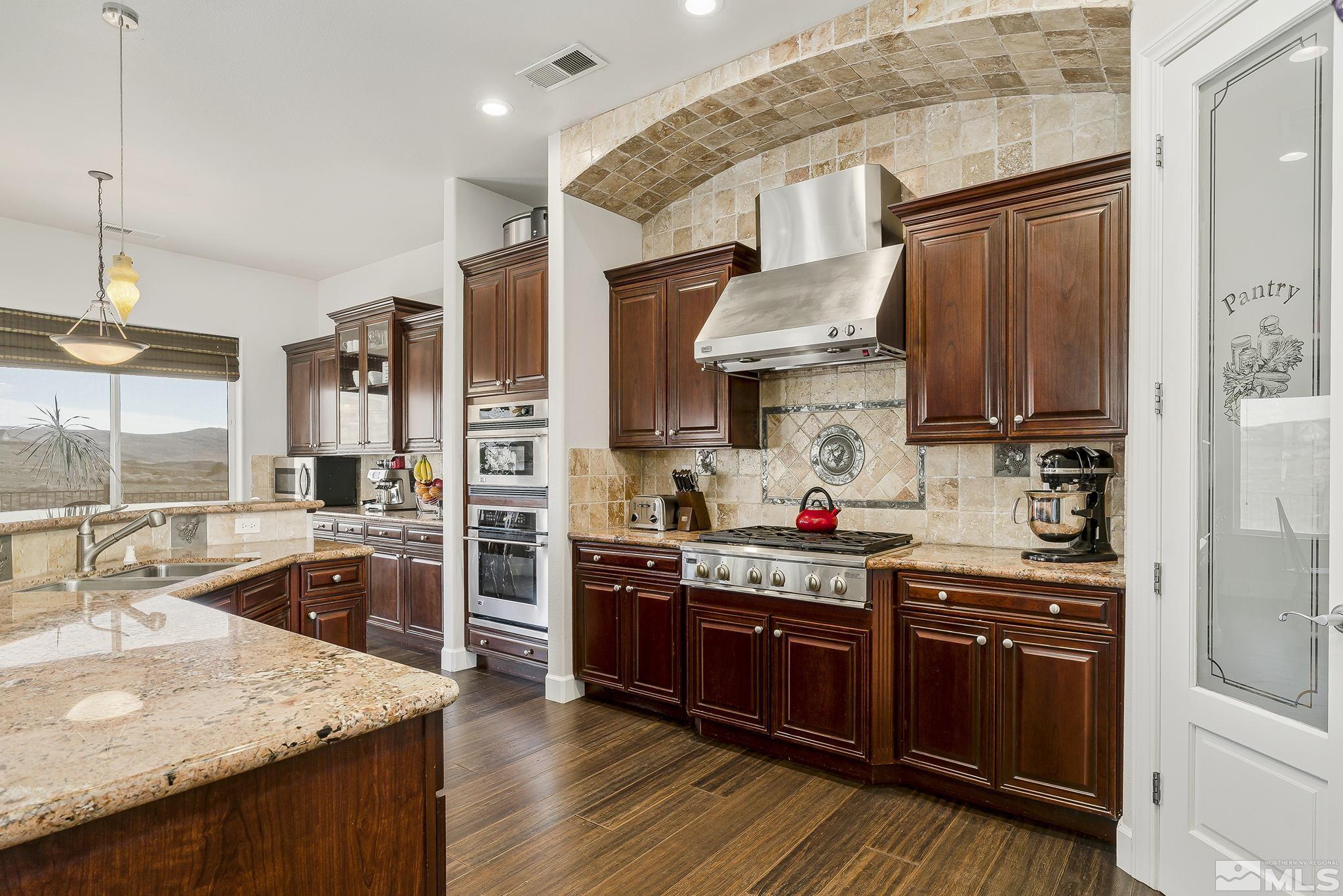 3528 Desert Fox Drive Sparks, NV 89436 - Photo 8 of 35 a kitchen with stainless steel appliances granite countertop a sink stove and refrigerator