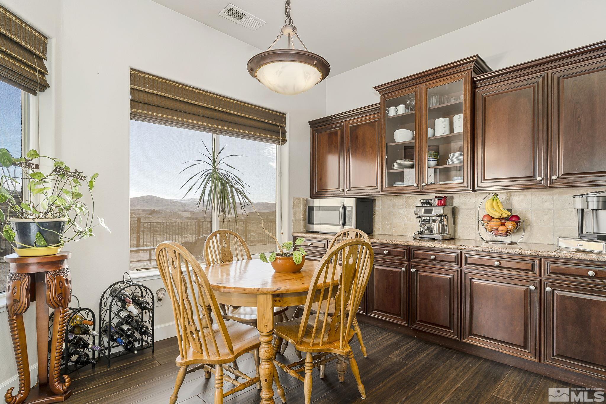 3528 Desert Fox Drive Sparks, NV 89436 - Photo 10 of 35 a dining room with stainless steel appliances granite countertop a dining table and chairs with wooden floor