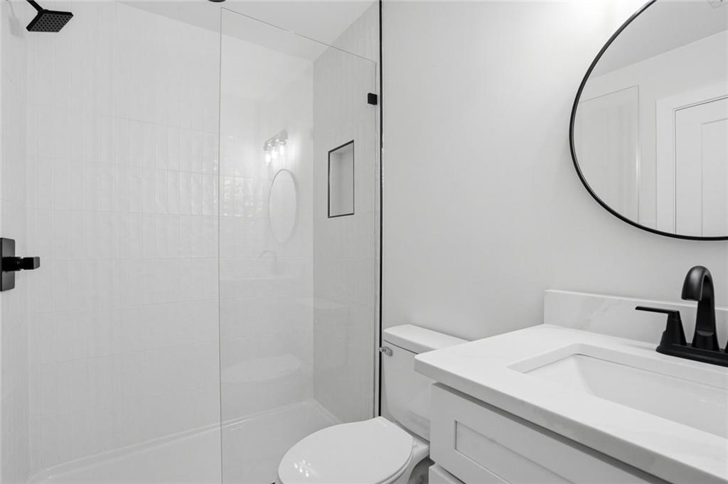 134 Henry Meyer Road Winterville, GA 30683 - Photo 22 of 34 a bathroom with a sink toilet and a mirror
