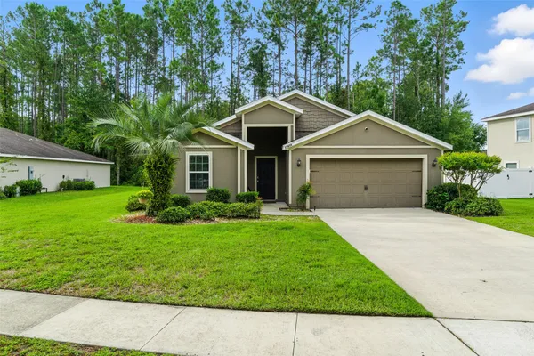 a view of a house with a yard