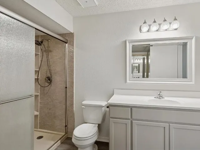 a bathroom with a sink toilet and shower