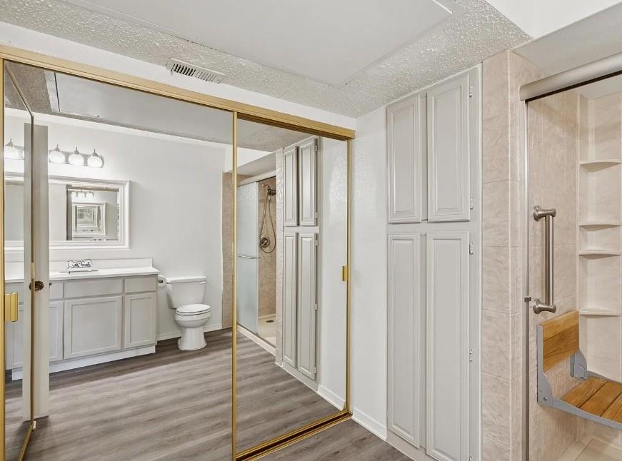 531 Ranch Trail, Unit 157 Irving, TX 75063 - Photo 14 of 21 a bathroom with a granite countertop sink toilet and shower