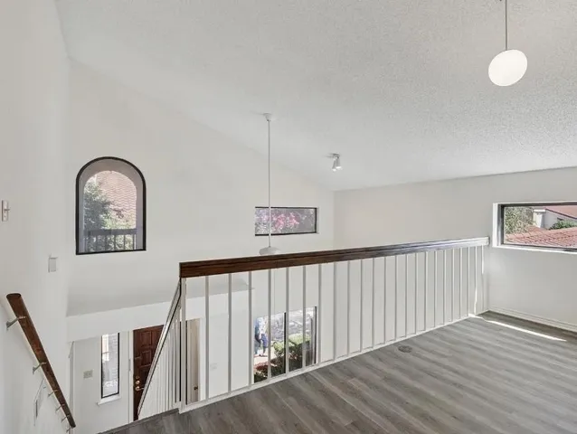 a view of staircase with wooden floor