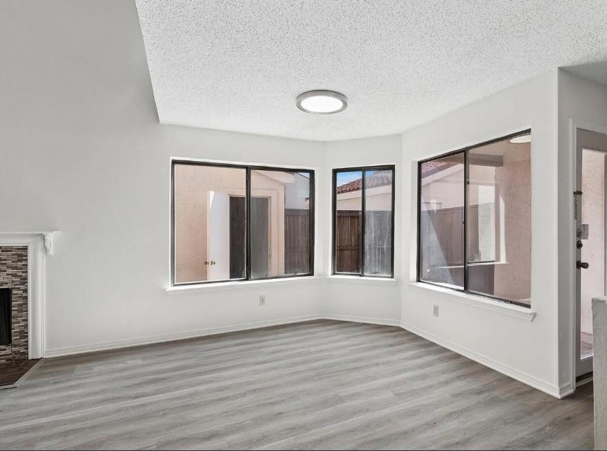 531 Ranch Trail, Unit 157 Irving, TX 75063 - Photo 18 of 21 an empty room with wooden floor and windows