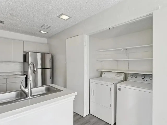 a kitchen with a refrigerator sink stove and cabinets