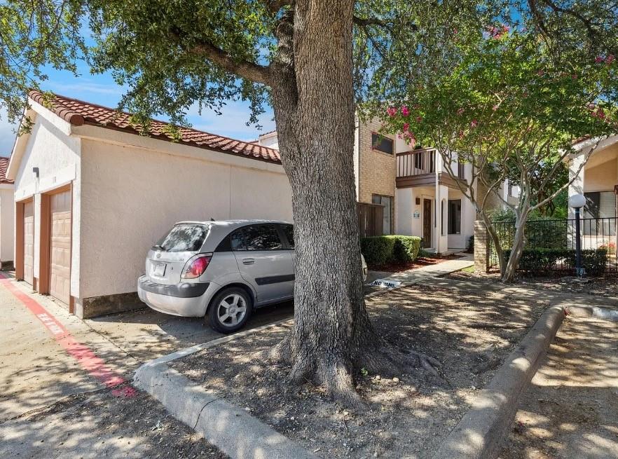 531 Ranch Trail, Unit 157 Irving, TX 75063 - Photo 2 of 21 a car parked in front of a white house