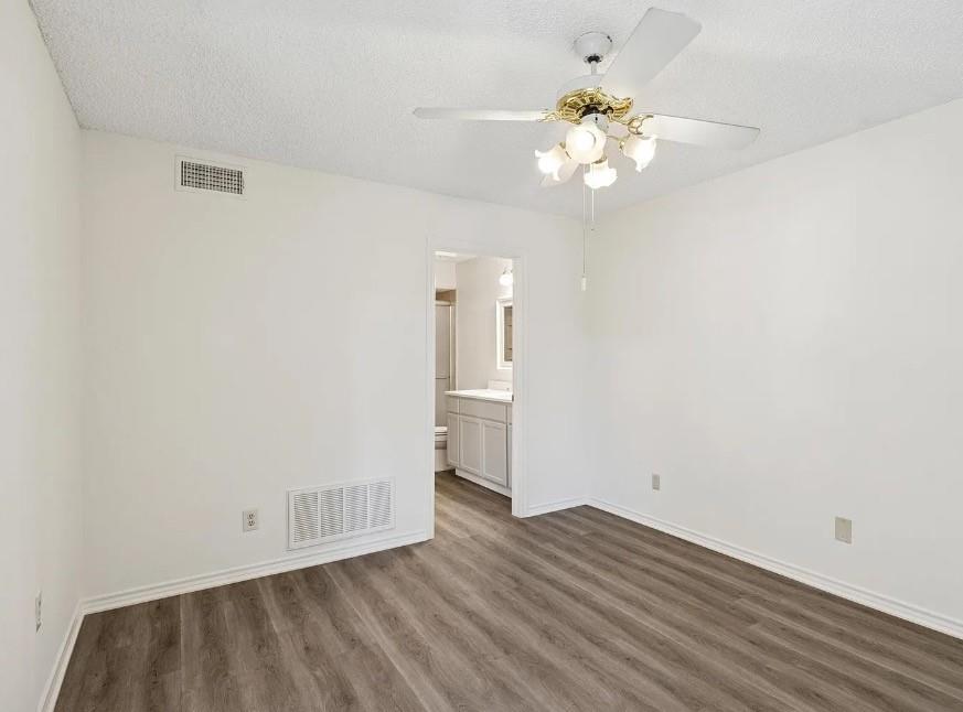 531 Ranch Trail, Unit 157 Irving, TX 75063 - Photo 21 of 21 wooden floor in an empty room with a window