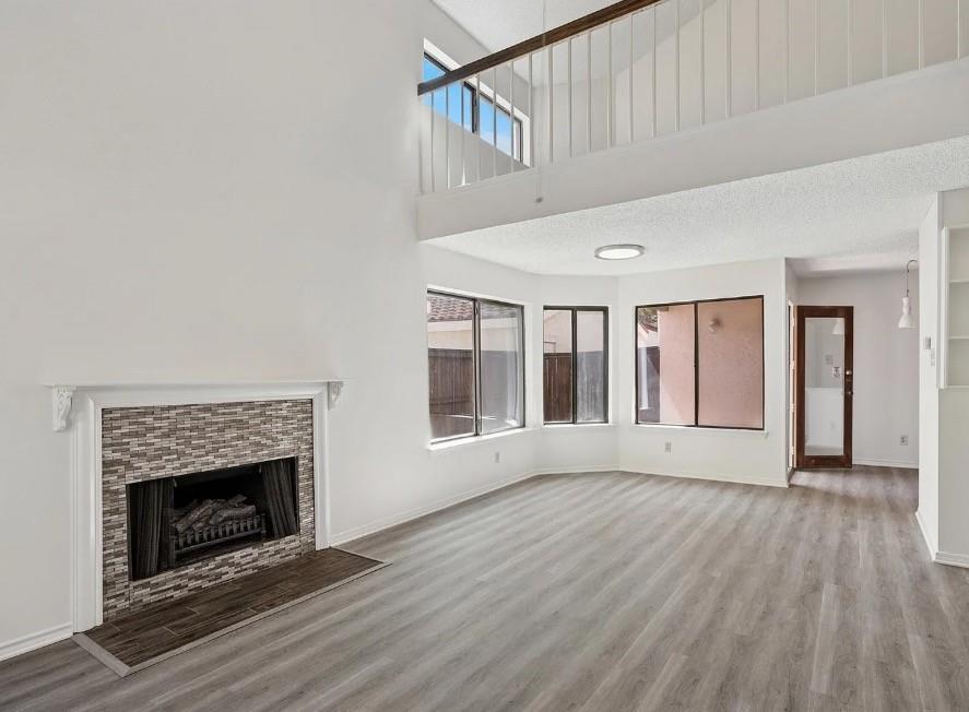 531 Ranch Trail, Unit 157 Irving, TX 75063 - Photo 3 of 21 a view of an empty room with wooden floor fireplace and a window