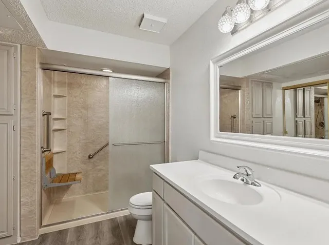 a bathroom with a sink toilet and shower