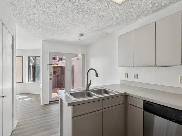 a kitchen with a sink and cabinets