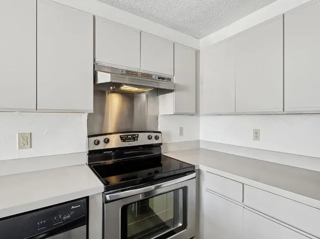 a stove top oven sitting inside of a kitchen